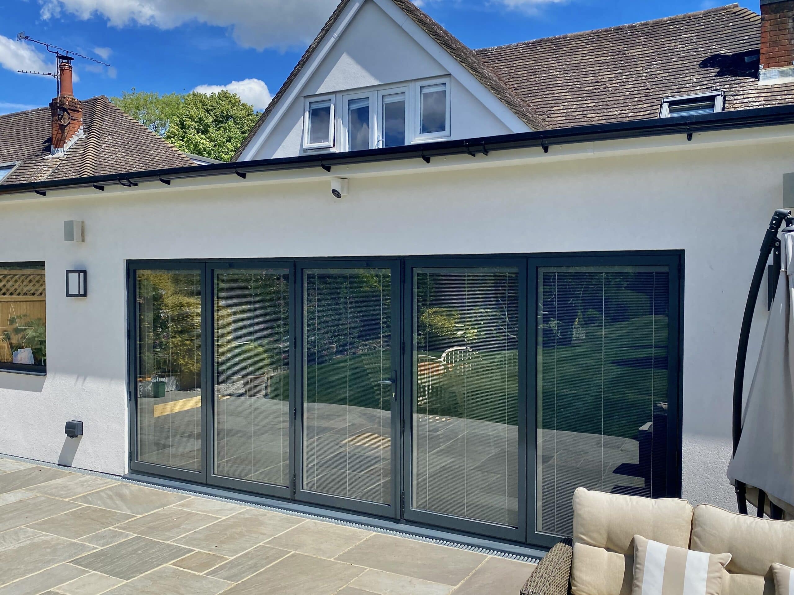 Alunet BF73 bifold doors grey colour, closed outside view with integral blinds. 