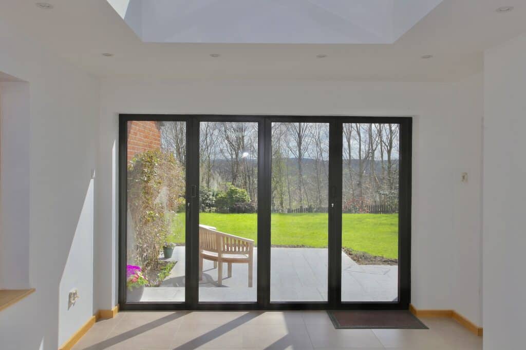 Alunet BF73 bifold doors in a modern room setting from a doors trade supplier