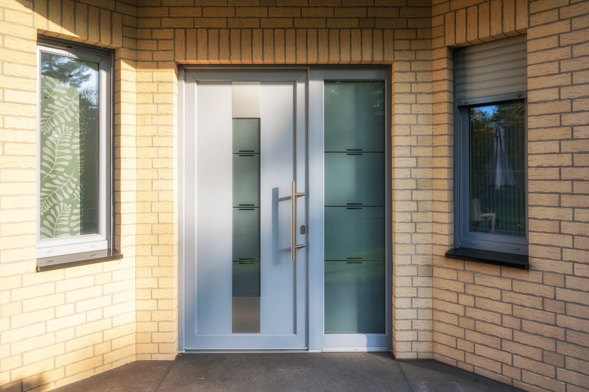 Modern house entrance door with windows for lots of light and a clinker facade