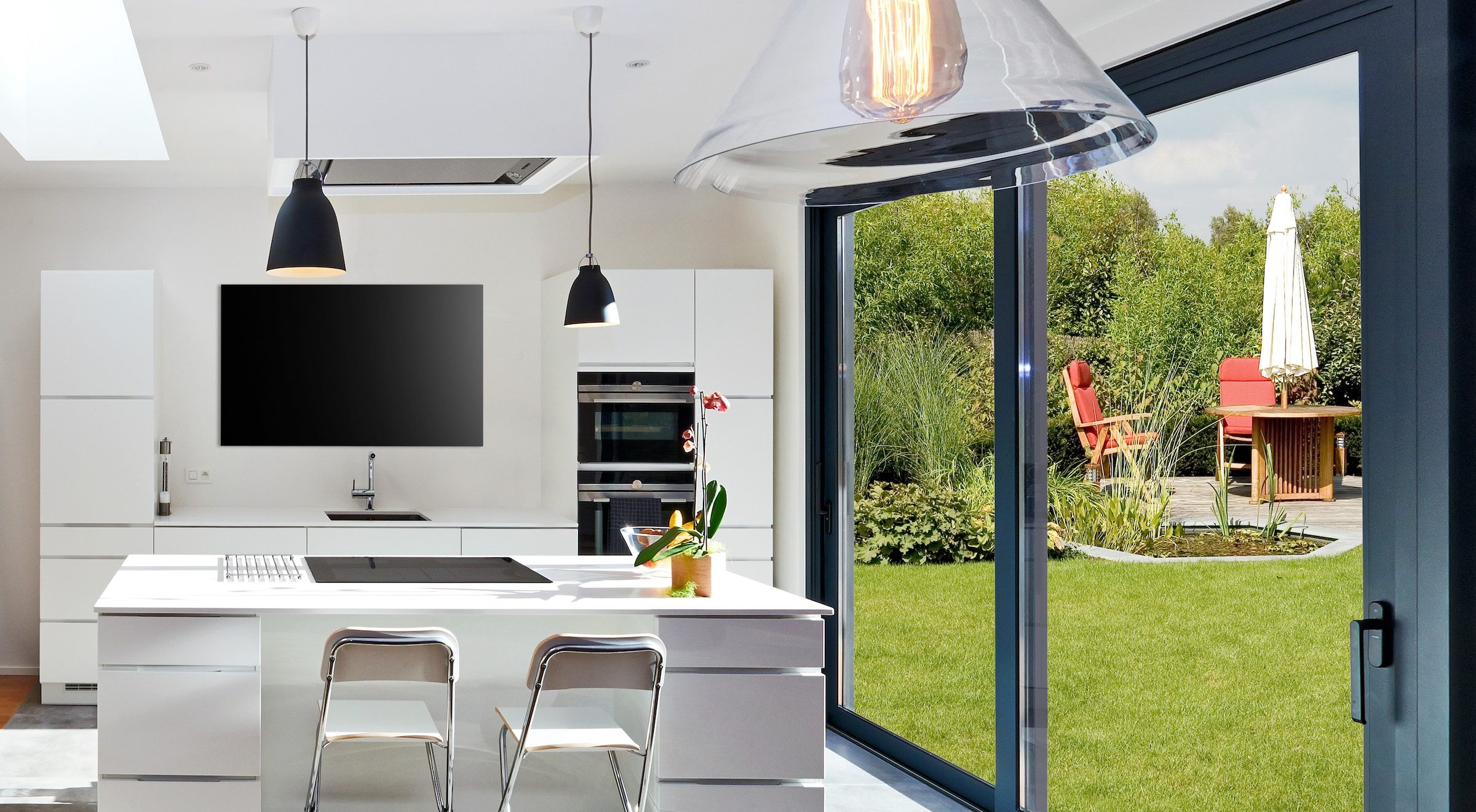 alunet black lift and slide doors with a fixed panel in a kitchen.