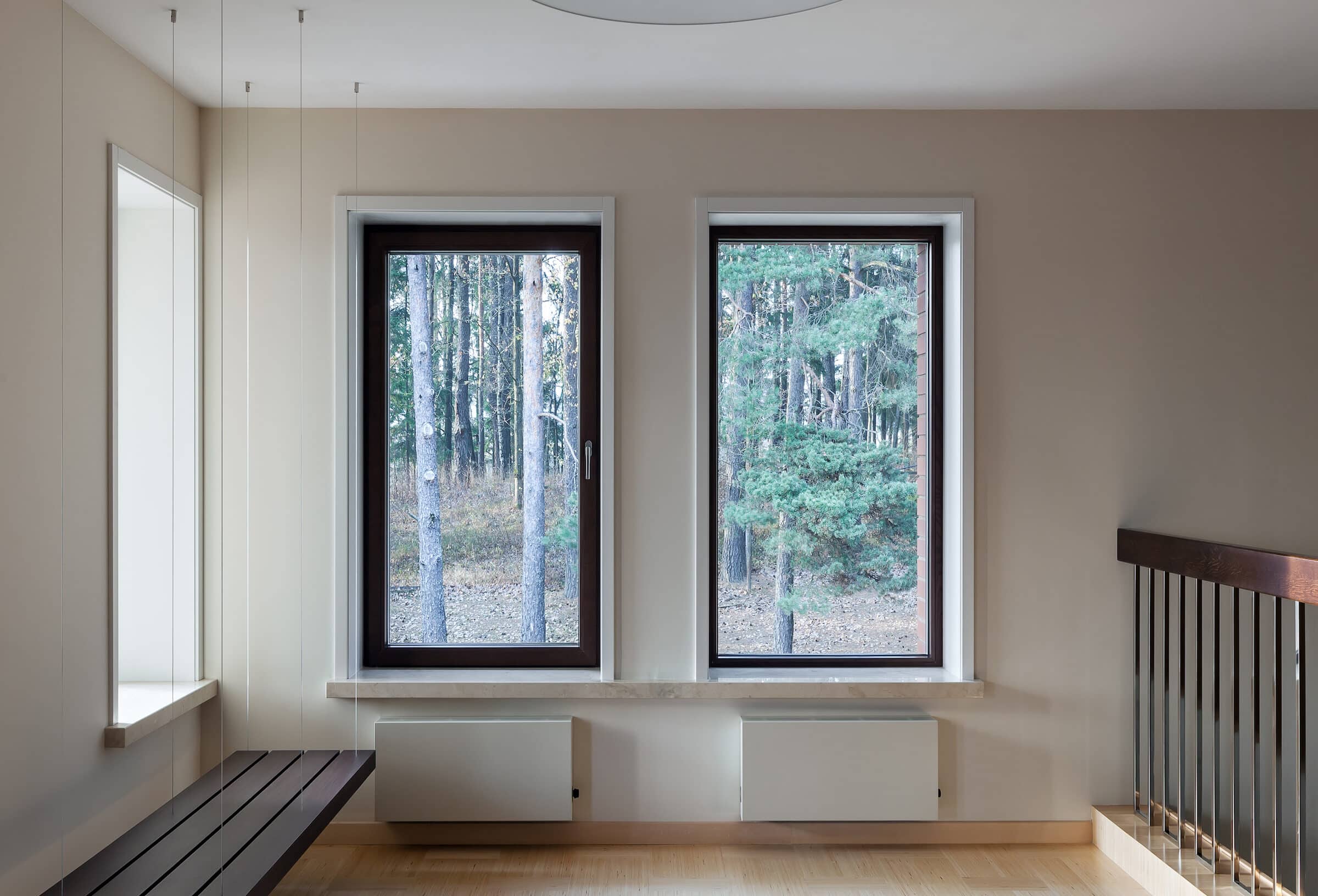 aluminium windows in modern empty space with suspended bench and big windows