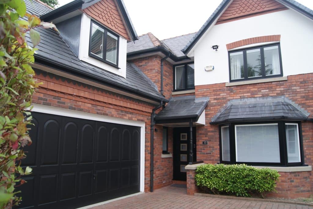 Two-storey house with black aluminium windows 